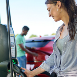 woman using EV charger